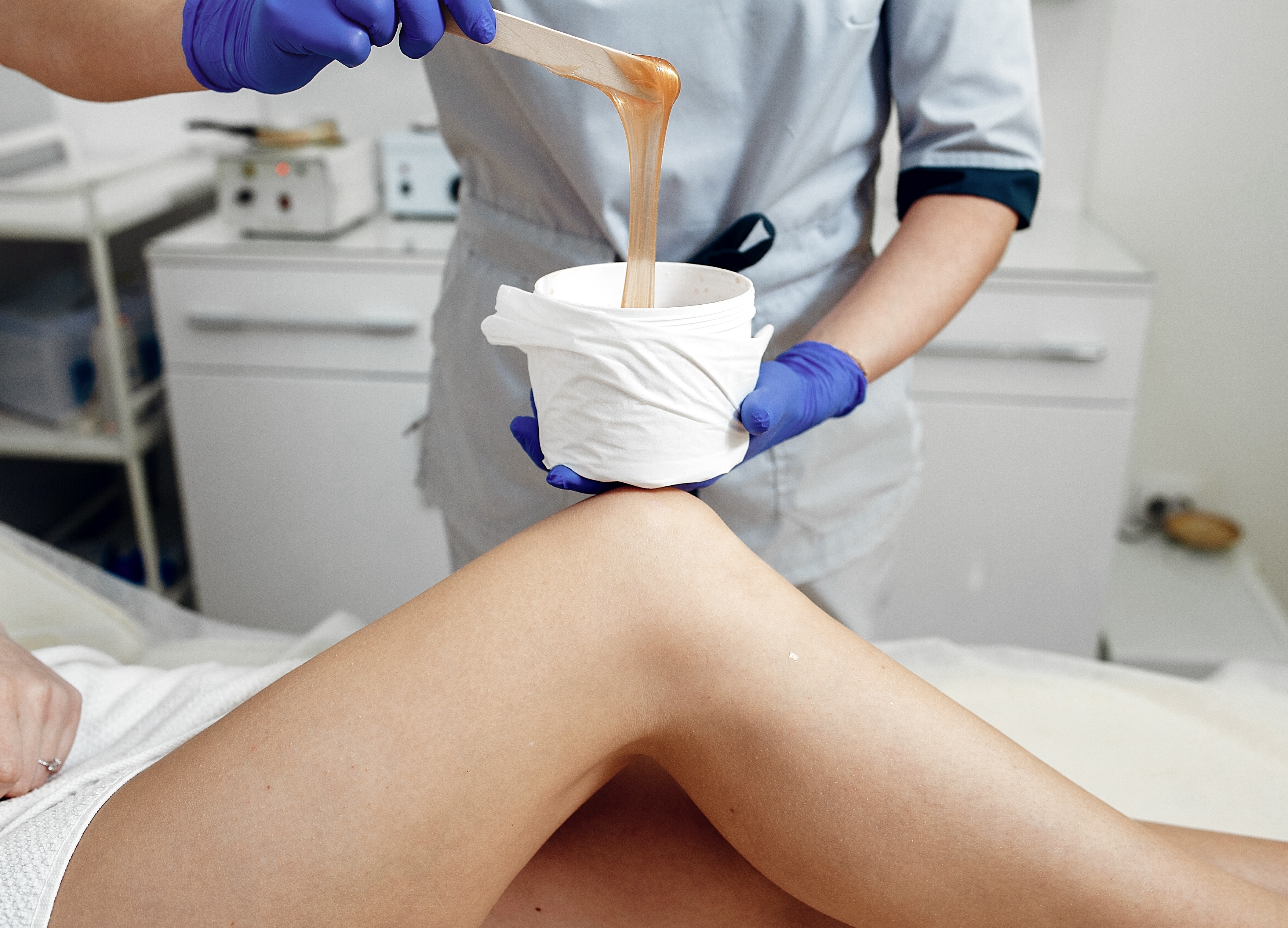 Image of a woman having her arms waxed