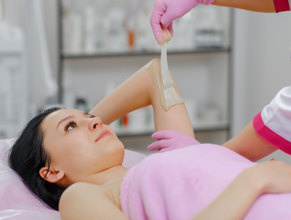 Image of a woman having her arms waxed